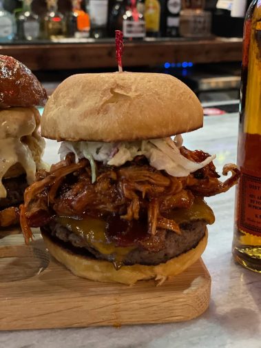 SWINE & DINE BURGER - SMOKED PORK, PICKLES, SOUTHERN SLAW, CHEDDAR, APPLE WOOD BACON & BBQ